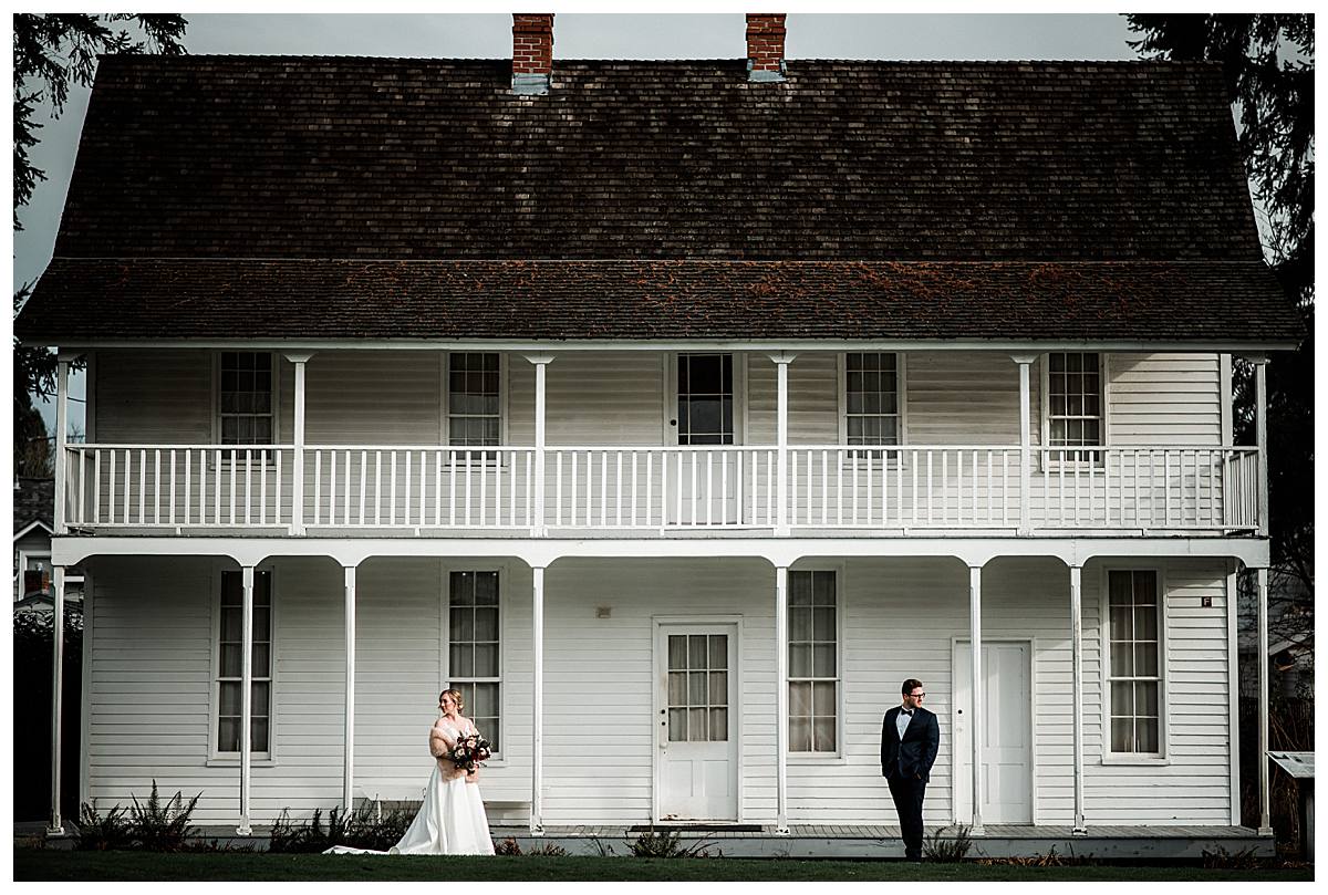 Bride and groom picture in front of a historic home on the grounds at the Willamette Heritage Center in Salem, Oregon.