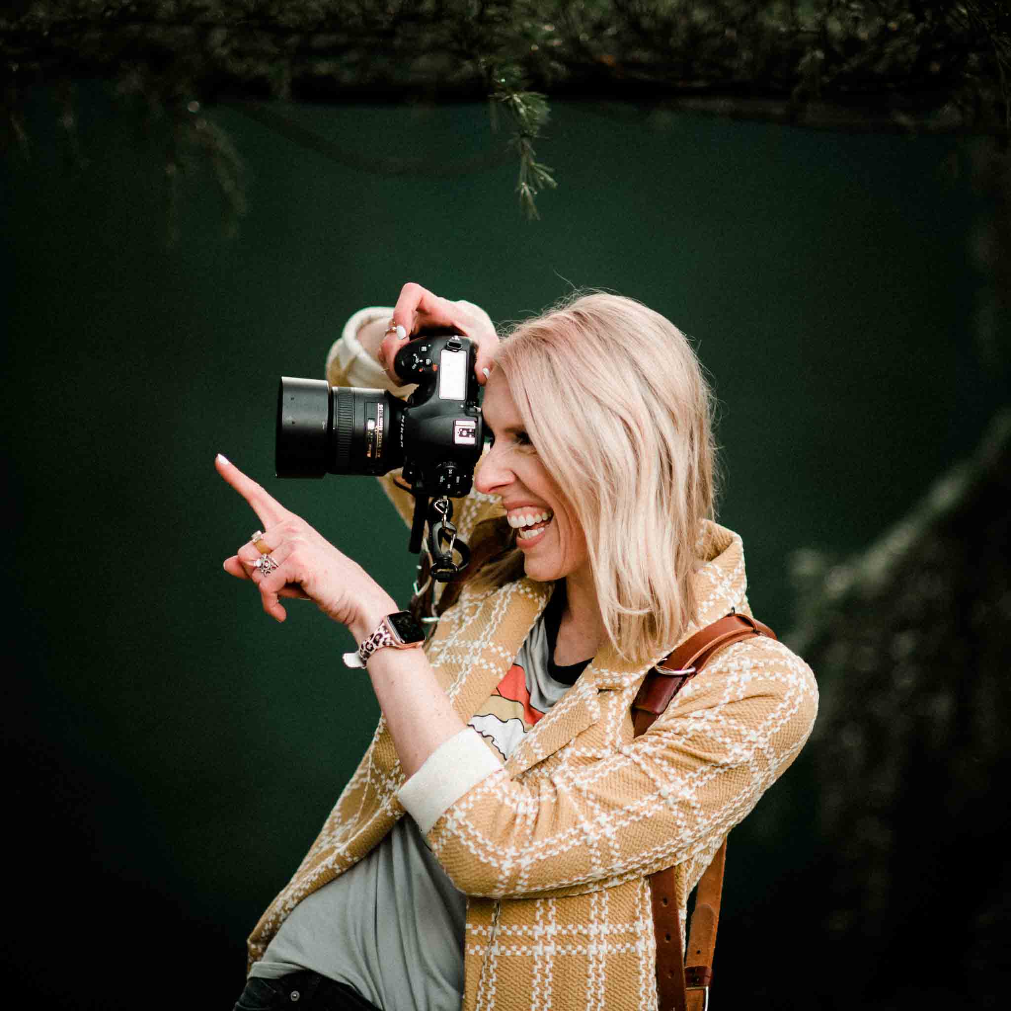 portrait of Oregon's best elopement photographer in the forest with her camera