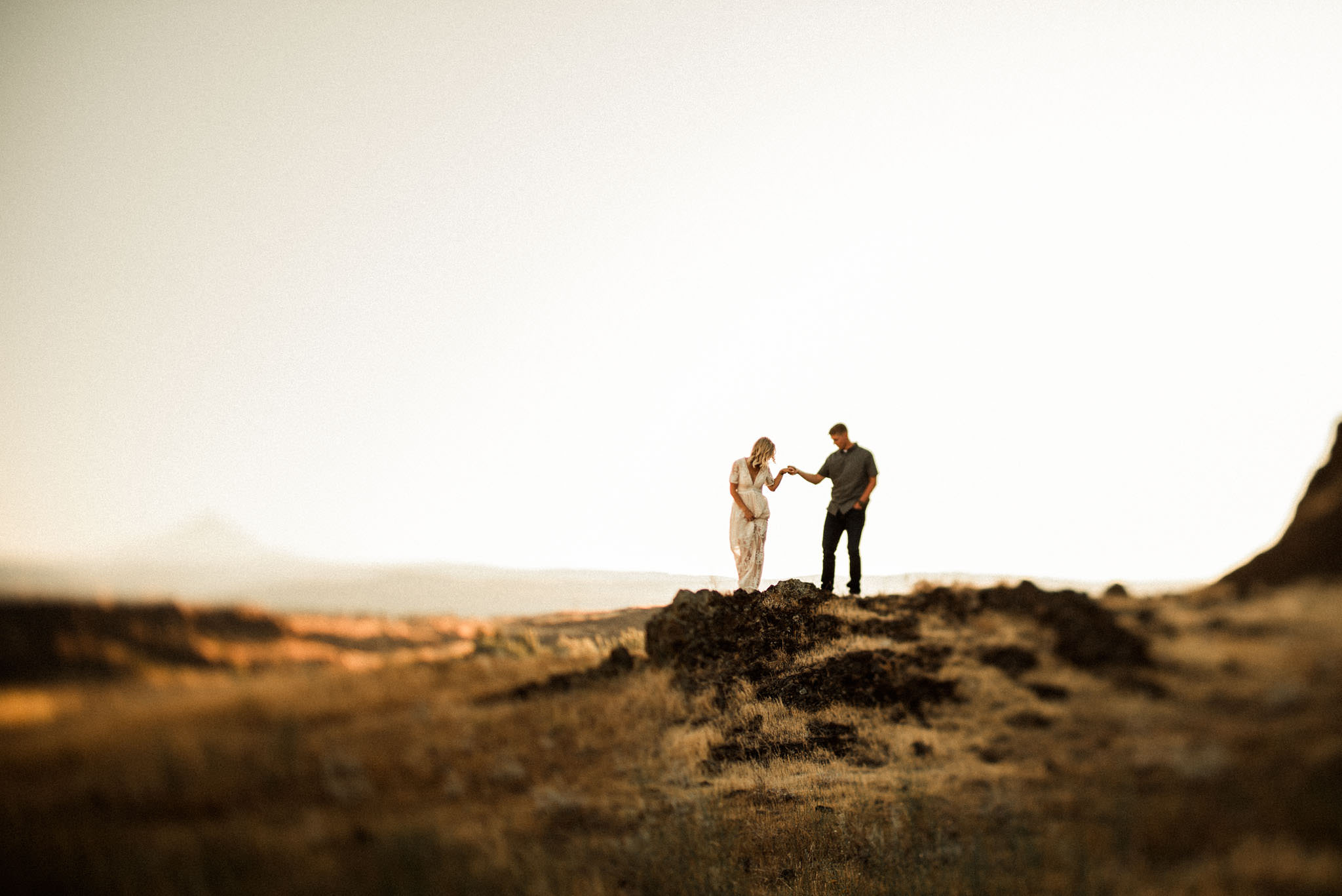Engagement session photograph during sunset on the top of a cliff at Horsethief Butte in Washington by Portland Photographer