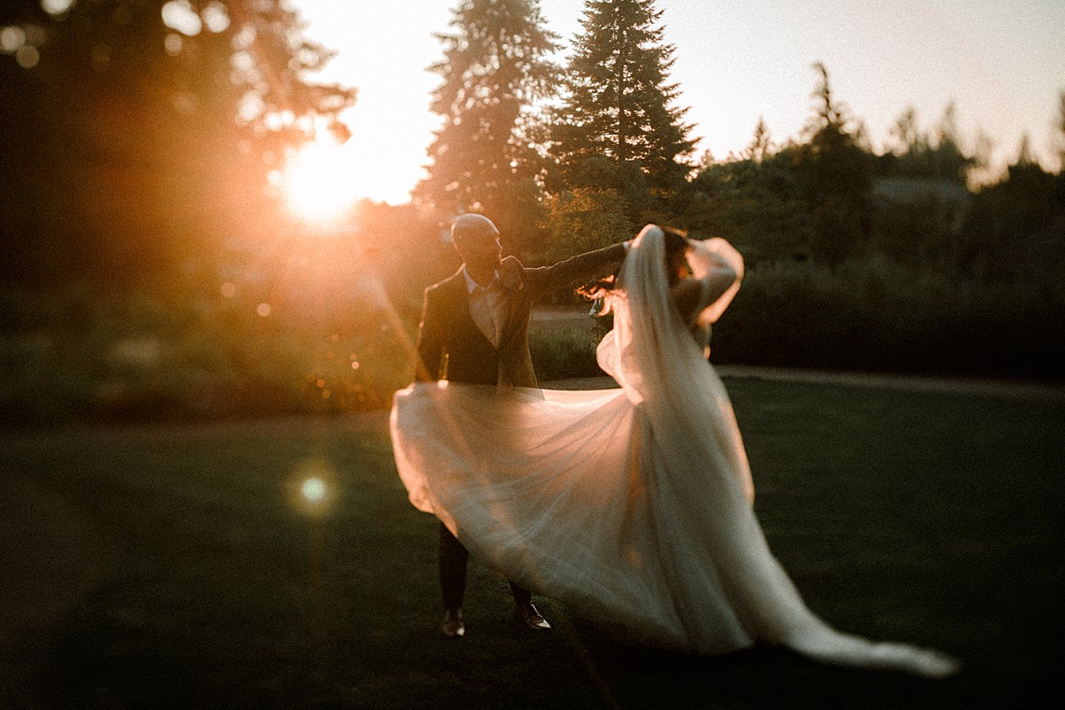 Sunset portraits of Bride and Groom dancing in the golden hour rays in the Leach Botanical Garden